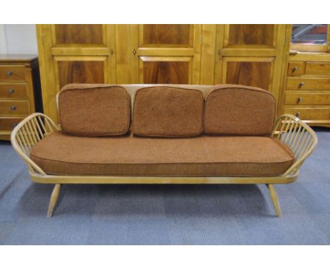A vintage Ercol beech day bed / 3 seater settee.
