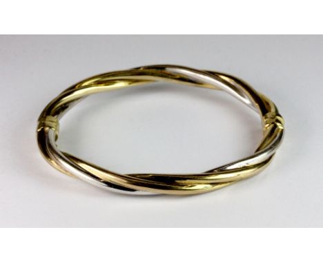 A 9ct gold 2 colour twist hinged bangle.