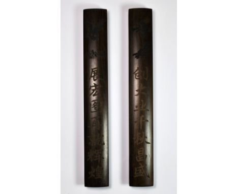 A pair of Chinese hand decorated hardwood scroll weights, L. 30cm.
