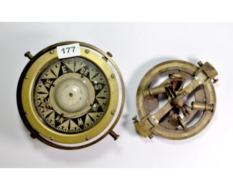 A brass gimble compass and a brass sextant.