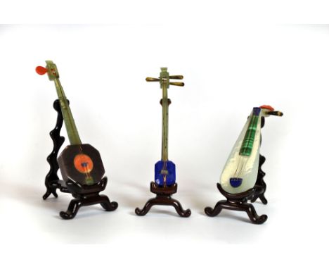 Three very fine miniature Chinese musical instruments made of jade, coral, malachite and lapis, H. 10cm.
