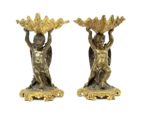 pair of antique baroque style table pieces in partially gilded bronze each with a cupid carrying a shell||Paar antieke barokk