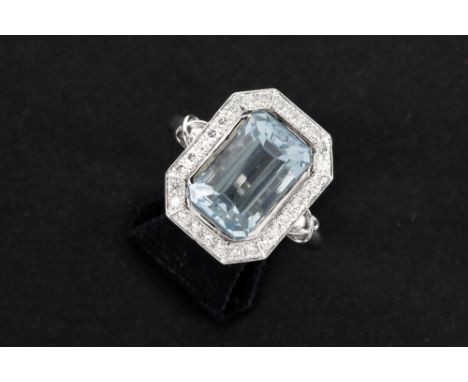 ring in white gold (18 carat) with a 6,24 carat blue radiant cut topaz surrounded by circa 1 carat of high quality brilliant 