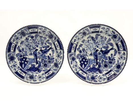 pair of round 18th Cent. dishes with a finely lobed rand in "BP" marked ceramic from Delft with a blue-white decor with flowe