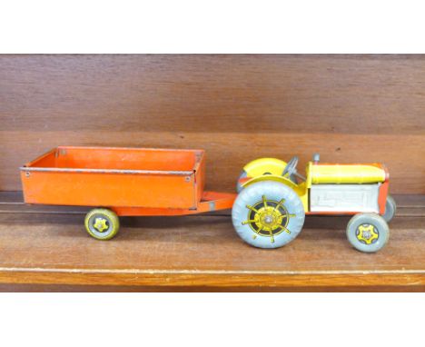 A Mettoy tin-plate tractor and trailer, 44cm