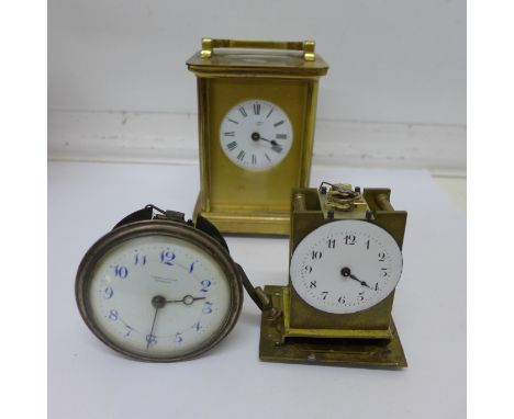 A brass carriage clock and two clock movements