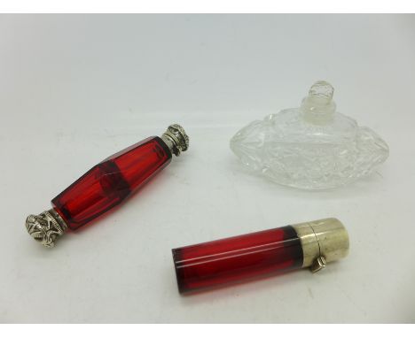 A white metal mounted double end ruby glass scent bottle, a white metal topped scent bottle, a/f, and one other scent bottle 