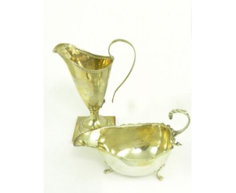 A VICTORIAN SILVER HELMET SHAPED CREAM JUG ON SQUARE FOOT, CHESTER 1898, HANDLE PARTLY DETACHED AND A SILVER SAUCE BOAT, 5 OZ