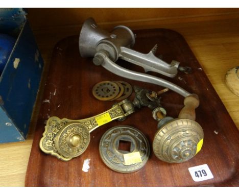 A vintage kitchen mincer together with a heavy elaborate brass door knob & knocker