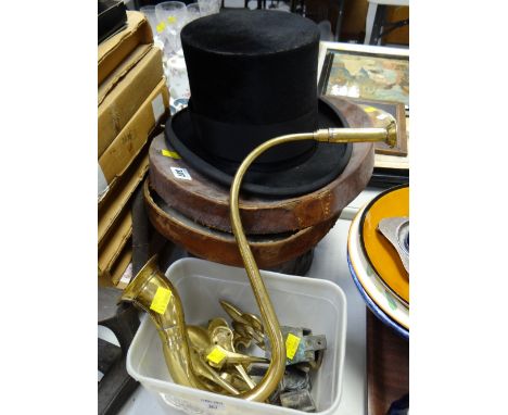 A vintage top hat in a leather box together with a brass ear trumpet