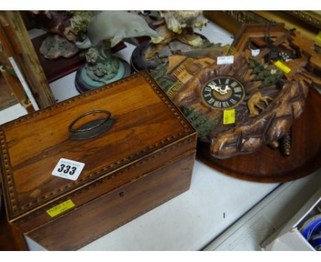 A believed walnut & inlaid tea caddy together with two tourist cuckoo clocks