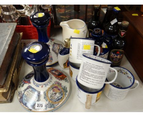 A collection of Wade Pusser's Rum ship's decanters, matching enamel drinking mugs, vintage bottles of commemorative ale