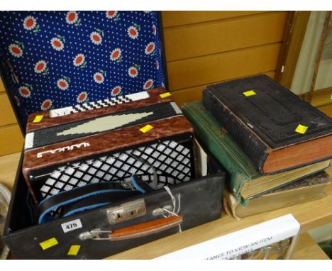 A cased piano accordion plus three vintage books including a Welsh Bible