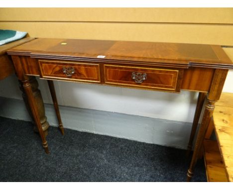 A reproduction mahogany narrow two-drawer console table together with a pair of reproduction mahogany astragal glazed hanging