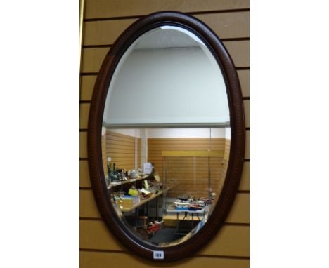 A vintage mahogany &amp; inlaid oval bevelled wall mirror together with two smaller vintage mirrors