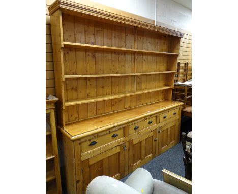 A large pine dresser, three-drawer three-cupboard base & three-shelf rackcondition:Width – 240cmsHeight – 220cmsDepth – 42cms