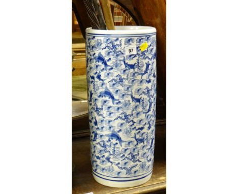 An Oriental-style pottery umbrella stand with stick contents including interesting carved walking cane & a silver handled wal