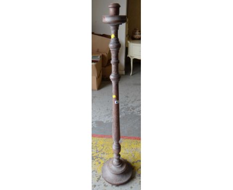 A limed oak floor standing candlestick