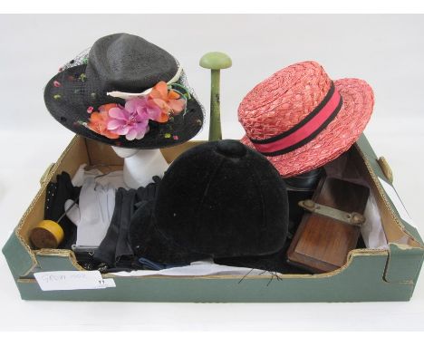 Vintage black straw hat with net detail, faux-flowers and a leaf, a pink straw boater labelled 'Miss Dolores', two small hat/