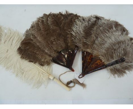 Two ostrich feather and tortoiseshell fans and a white ostrich feather fan with ivory handle (3)Condition ReportLight brown f