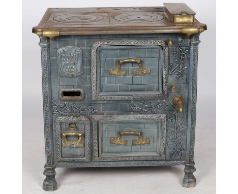 An early 20th century "Faure Pere &amp; Fils Revin Ardennes" cooker, having a iron stove top and hand rail above a ceramic br