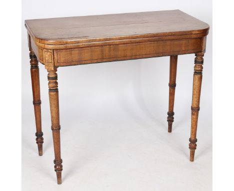 A 19th century mahogany fold over card table, having a green baize interior raised on a inlaid frieze and turned legs, 88cm w