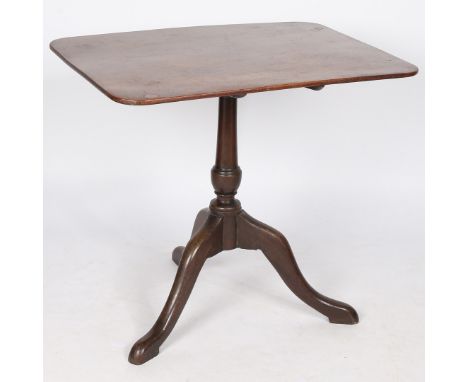 A George III mahogany occasional table, having a rectangular top with chamfered edges above a gun barrel column and tripod le