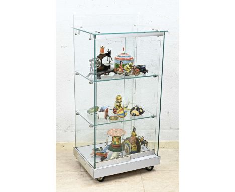 Glass display case filled with old/antique tin toys. Among other things; Germany, Japan. Among other; Schuco engine etc. Dime