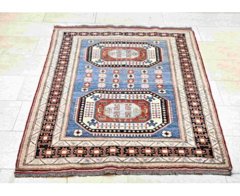 Hand-knotted Persian rug. Color scheme: light in color, red/blue, with two medallions/animals and figures in the middle. Dime