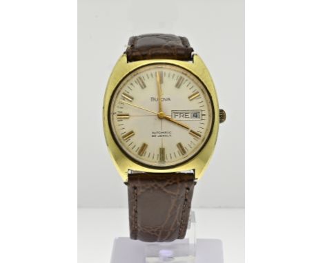 Vintage Bulova watch, automatic, with a gold-plated case and a cream colored dial with day and date indication. The watch has