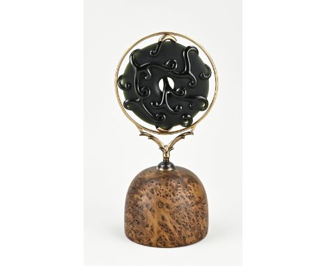 Exclusive New Zealand Maori artwork. Made of carved jade, placed in an 18 carat gold holder with a root wood base. So-called 