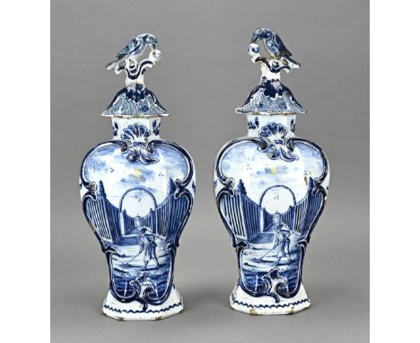 Two 18th century Delft fayence lidded vases with architectural decor. With bottom mark CF. Both lids (bird) glued. Dimensions