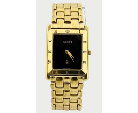 Vintage Gucci watch, gold on steel, with a rectangular case, a bezel with Roman numerals and a black number plate. The watch 