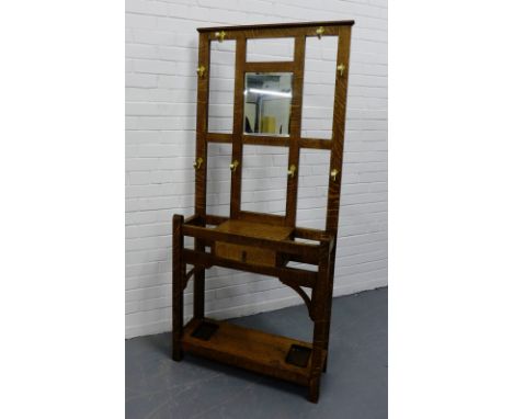 Oak hall stand, the dentil frieze top over mirror back and central drawer with brass and ceramic hooks, 175 x 79cm