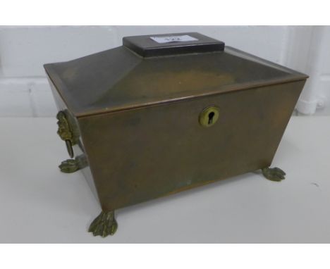 Copper tea caddy of sarcophagus form, with lion twin mask handles to side, raised on hairy paw feet, 21 x 11cm 