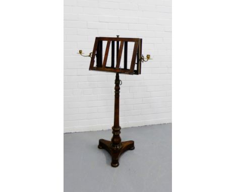 19th century rosewood duet music stand, with brass candlestick holders to side, on turned column support and tripod base, on 