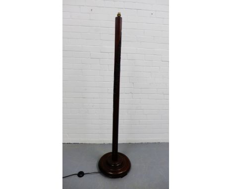Eastern standard lamp, the stained wood column with carved scene depicting pagodas on circular base, 160cm high