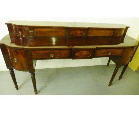 Regency mahogany bowfront stageback sideboard with three frieze drawers flanked by panel cupboard doors, on turned and reeded