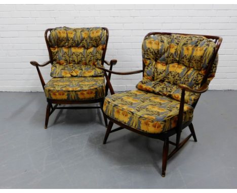 A pair of Ercol dark elm, spar back armchairs with upholstered seat pad and cushions (2) 82 x 72cm