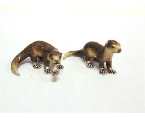 A PAIR OF SATURNO SILVER AND ENAMEL OTTERS,  the larger approximately 6cm long