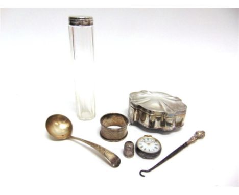 A SILVER TRINKET BOX a silver sauce ladle; a silver napkin ring; a glass toothbrush bottle with silver lid; a silver fob watc