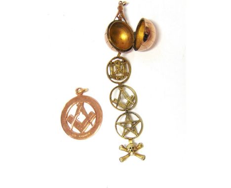 AN UNUSUAL MASONIC FOB in the form of an orb surmounted by a star and compass, opening to reveal four fold out and drop down 