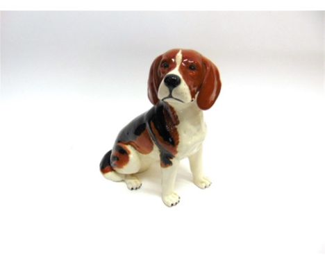 A CERAMIC FIRESIDE FIGURE OF SEATED BEAGLE 33cms high