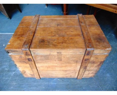 A LARGE TEAK TRUNK  with iron carrying handles, 92cm wide 63cm deep 61cm high