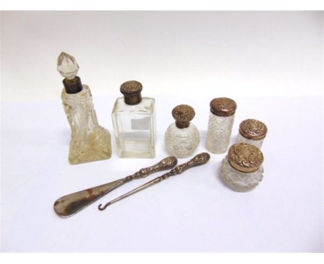A SILVER MOUNTED GLASS SCENT BOTTLE  Birmingham 1905; with five glass toilet bottles with silver covers; 27g gross weighable;