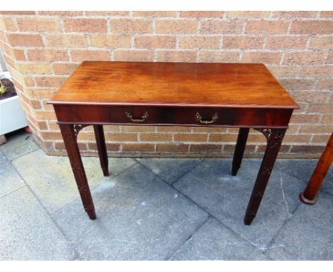 A CARVED MAHOGANY SIDE TABLE IN THE MANNER OF CHIPPENDALE,  single drawer to frieze with cast rococo handles, the chamfered s