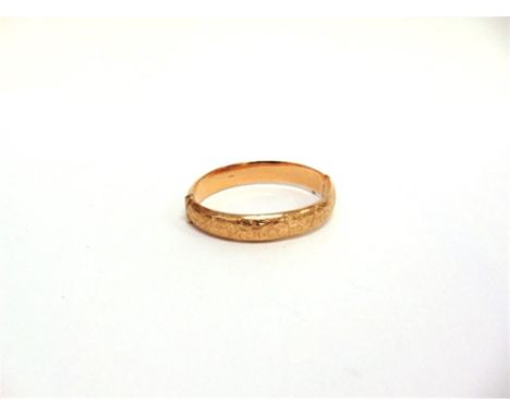 A 9 CARAT GOLD HINGED BANGLE Chester 1911, half engraved decoration, 1.3cm wide, 6.5cm internal diameter, 26.5g gross