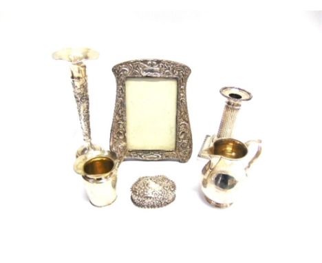 A COLLECTION OF SILVER ITEMS comprising: a sparrow beak cream jug; another smaller cream jug; and Edwardian shell shaped embo