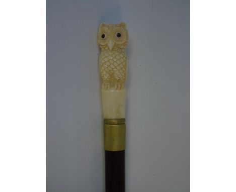 Carved bone top walking stick in the form of an owl