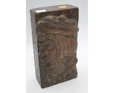 An oak panel, carved with a male head and shoulders, h.29cm